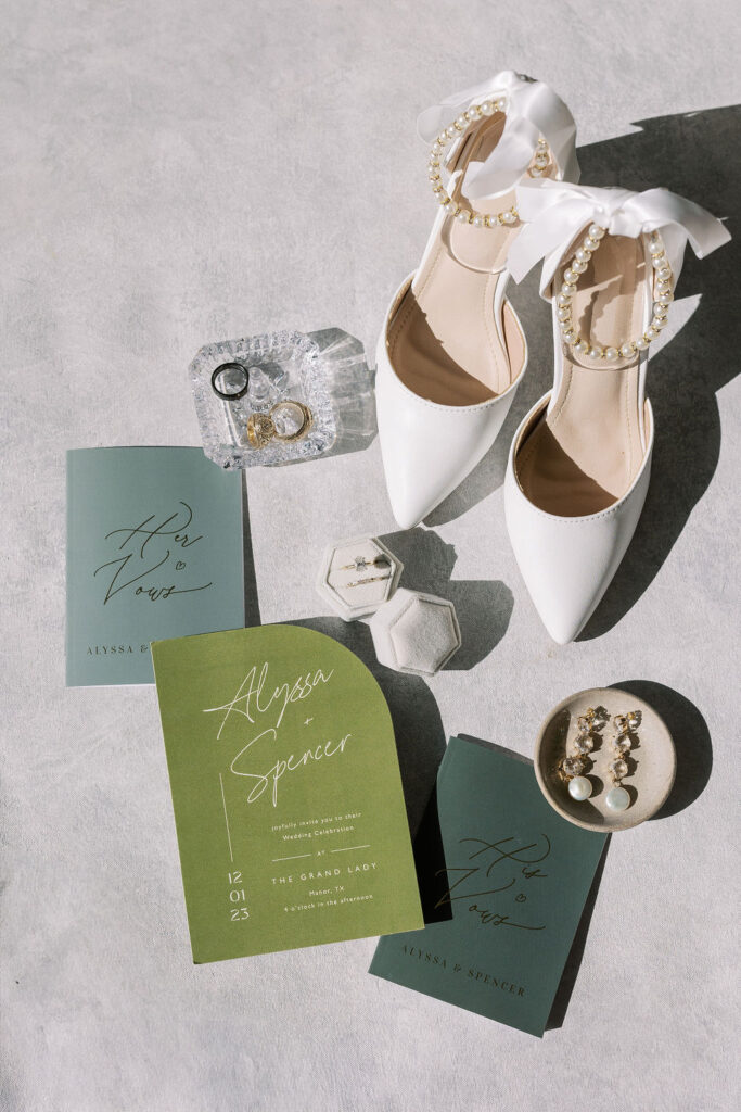 A flatlay with wedding vows, the bride's shoes, and other wedding day details.