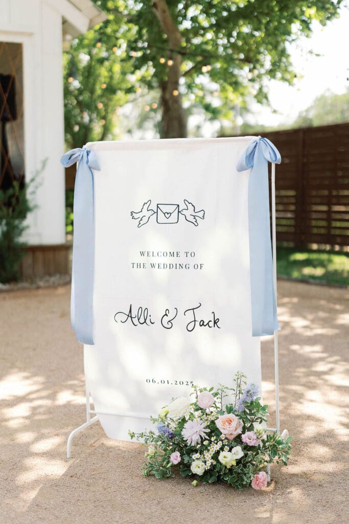 Linen wedding welcome sign with light blue ribbon bows in the Texas Hill Country.