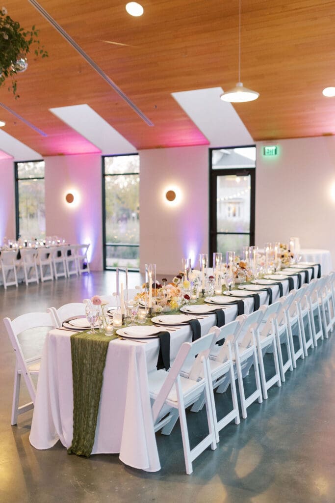 Modern reception setup at the Grand Lady Austin with uplighting, black and white linens, and soft candlelight—an Austin wedding planner's take on wedding design ideas on a budget.