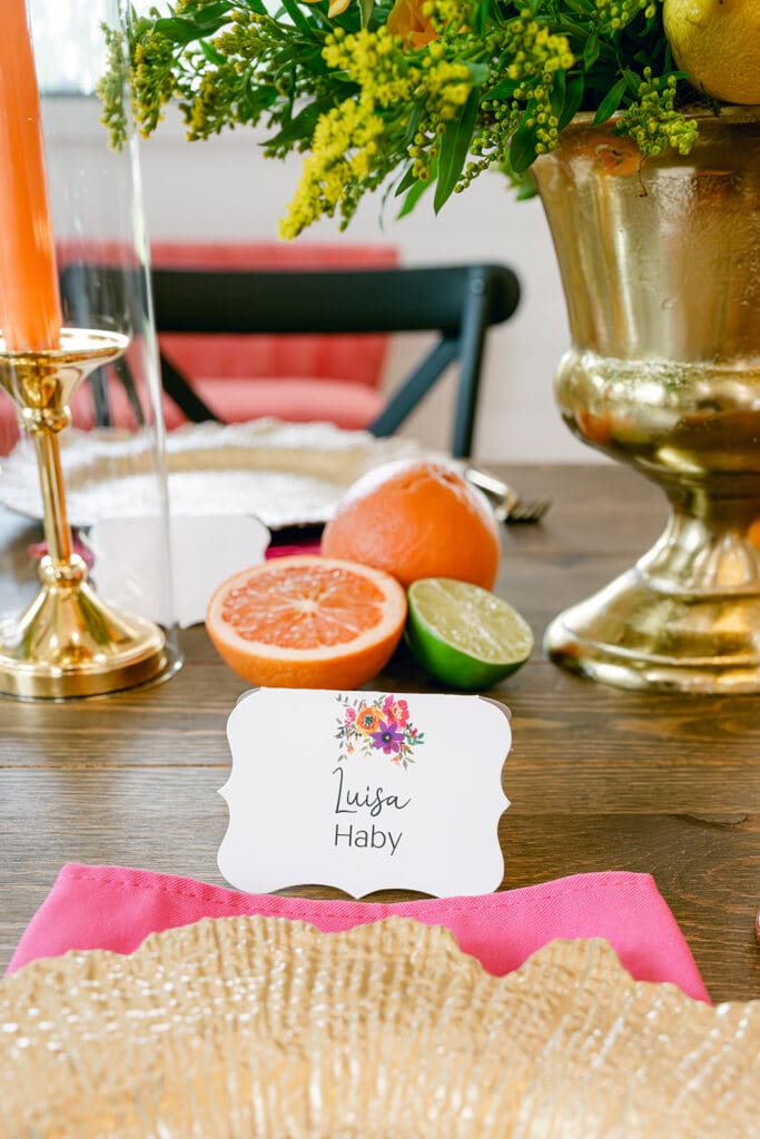 Vibrant place card setup with citrus decor and colorful napkin, styled by a Hill Country wedding planner known for fun, personalized wedding design ideas on a budget.