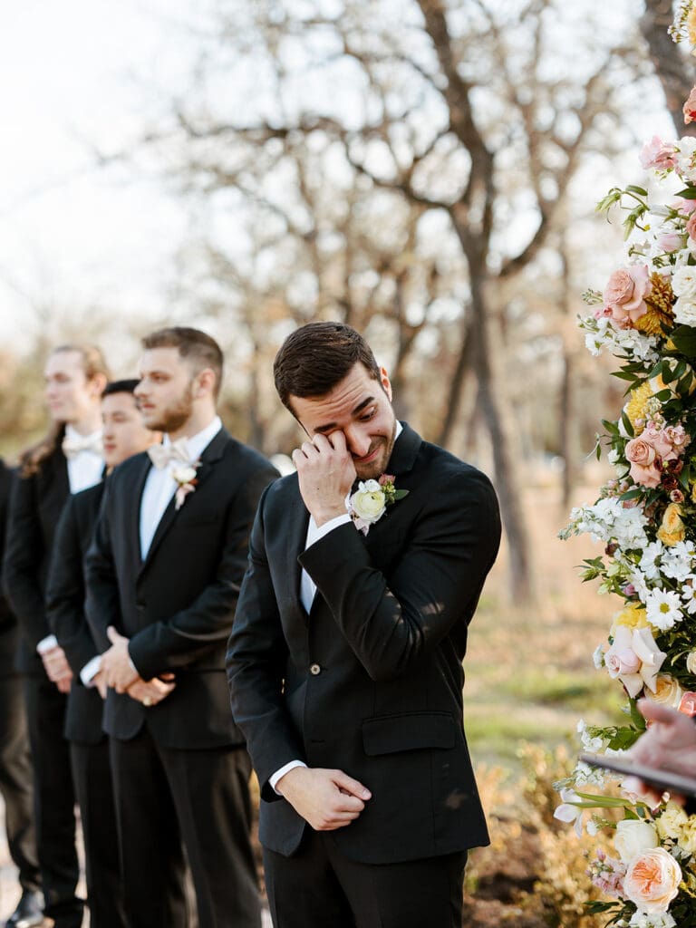 Groom getting emotional during a fall wedding ceremony in Texas