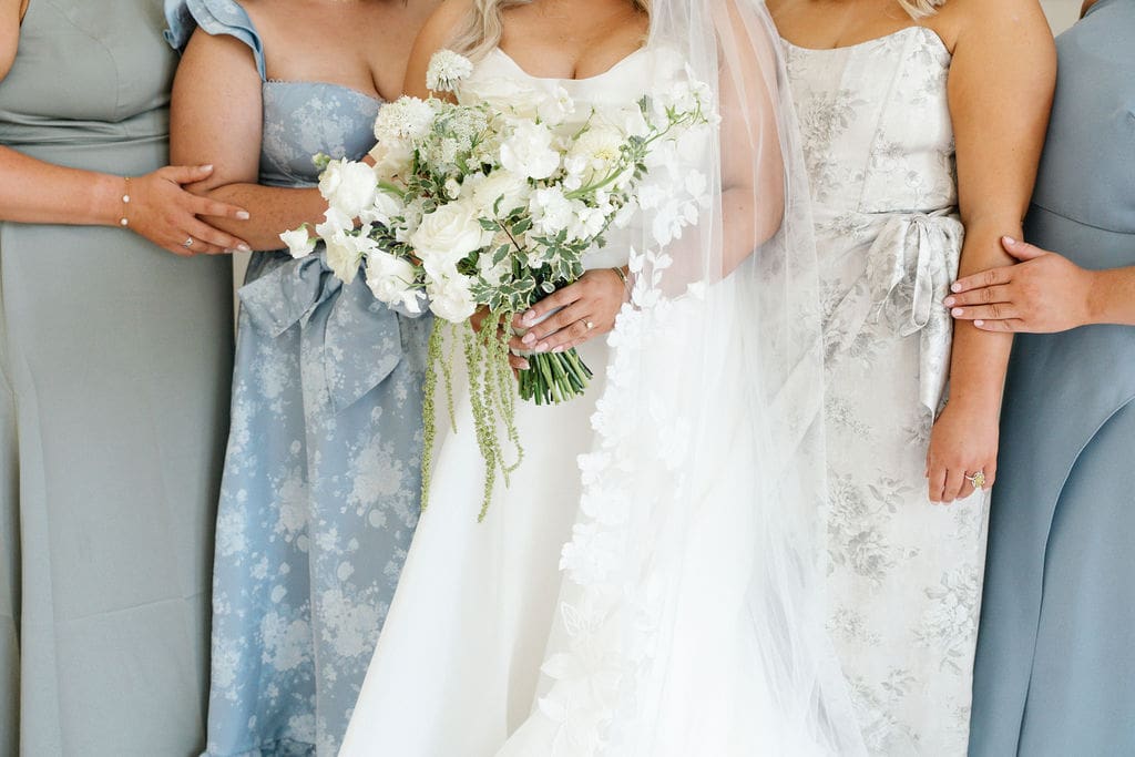Beautiful blue and white wedding with bride holding a modern white bouquet - planned by Austin wedding planner
