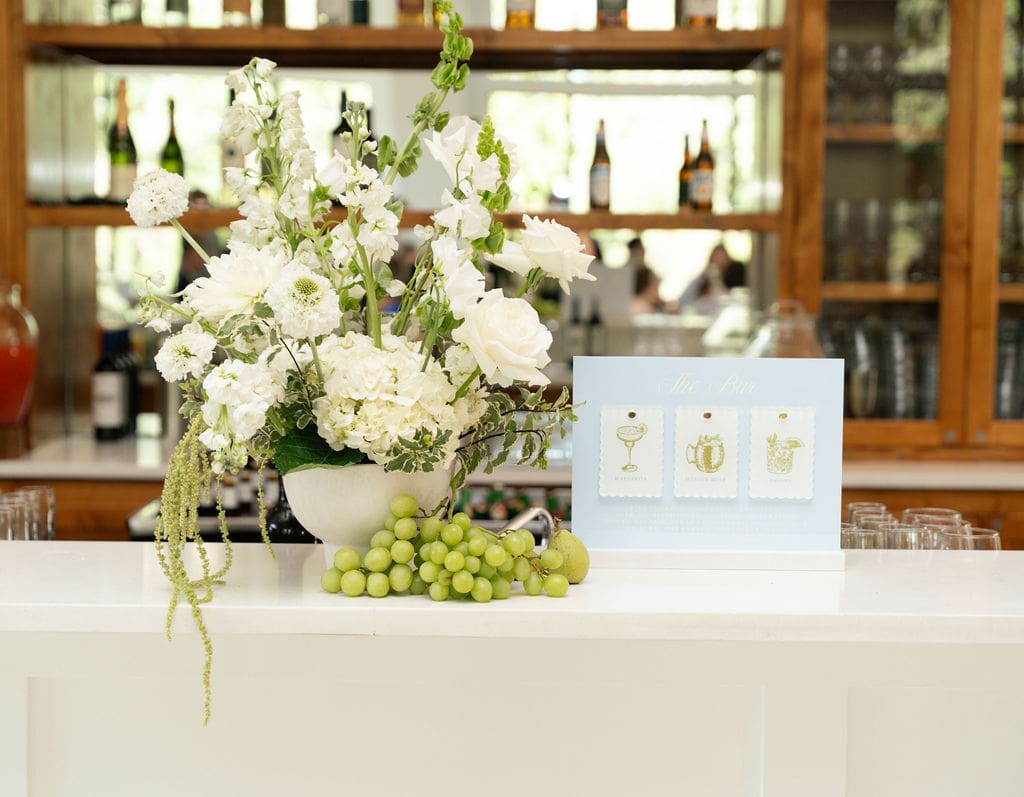 Wedding floral design with cute bar sign